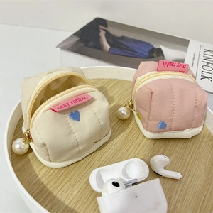Detailed close-up of quilted heart embroidery bags with pearl zipper and gold metal hardware
