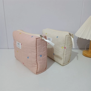 Quilted heart embroidery cosmetic bags in pink and cream with elegant ribbon zippers
