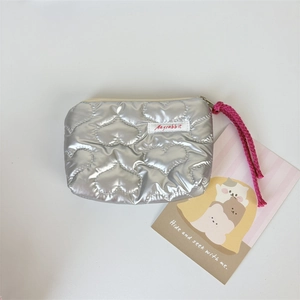 Close-up of silver quilted heart coin purse with Mayrabbit label and pink strap