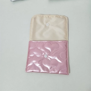 Detailed view of the snap button closure and pink heart embossed PU leather texture