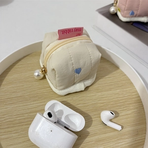Quilted heart embroidery pouch with pearl charm and AirPods for size reference