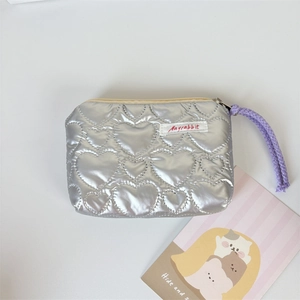 Close-up of silver quilted heart coin purse with metallic finish and Mayrabbit label
