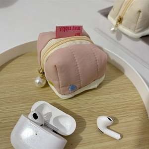 Pink quilted pouch with pearl zipper and heart embroidery for headphones storage