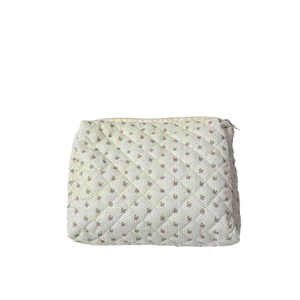 Quilted floral makeup bag with purple flower patterns and a sturdy zipper closure