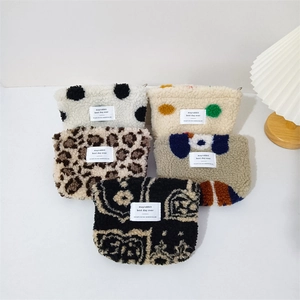 Plush leopard and dot print cosmetic bags in soft fleece with various patterns