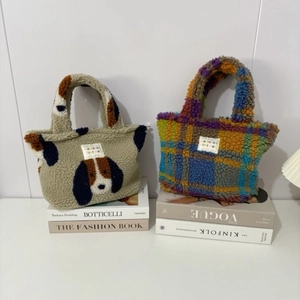 Detail of plush teddy fabric handbags with puppy print and colorful plaid patterns
