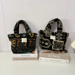 Detail of plush tote bags with vintage patterns on stylish fashion magazines
