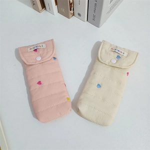 Quilted fabric storage pouch with colorful heart embroidery and white snap button closure