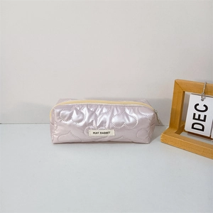 Close-up of lilac heart-quilted stationery bag with MAY RABBIT label and metal zipper