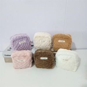 Six assorted colors of plush square mini storage bags with soft faux fur and zippers