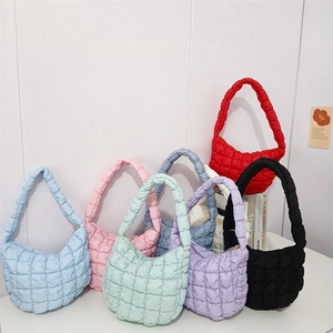 Detailed view of cloud-shaped puffer bags in various colors with quilted bubble texture