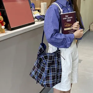 Large blue and black tartan canvas tote bag with wide shoulder strap for daily use