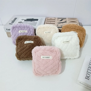 Plush faux fur makeup bags with diamond stitching in various colors for storage