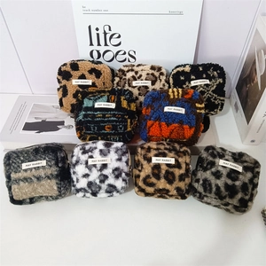 Macro shot of plush leopard print pouches with woven MAY RABBIT labels in various patterns