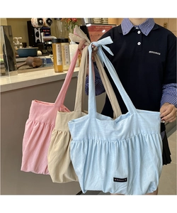 Three pleated cotton linen tote bags in pink beige and blue colors shown in detail