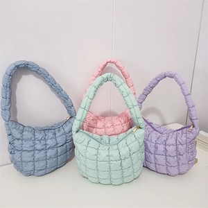 Quilted bubble tote bags in blue, pink, green, and purple with square pattern details