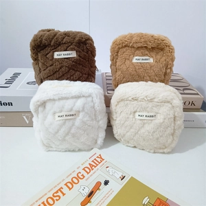 Quilted plush storage bags set in soft faux fur with top zipper for compact organization