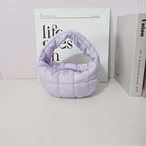Detail view of a lilac quilted cloud handbag with bubble texture and puffer fabric