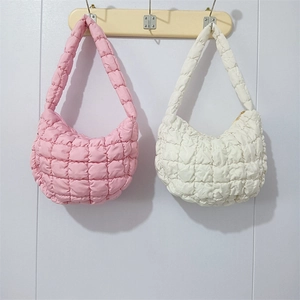 Detail of the quilted bubble texture on pink and white pleated cloud shoulder bags