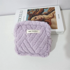 Close-up of purple plush bag featuring V-shaped quilting and a soft faux fur texture