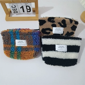 Plush lamb wool cosmetic pouch set with leopard, plaid, and stripe patterns for travel use