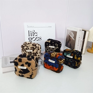 Detailed view of plush square pouches with multiple patterns and May Rabbit label