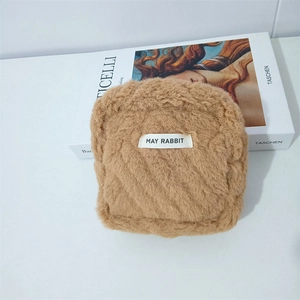 Detailed view of plush brown storage bag with MAY RABBIT label and fluffy texture