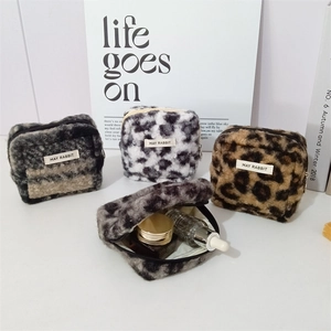 Plush animal print cosmetic bags in leopard and spotted patterns with zipper closure