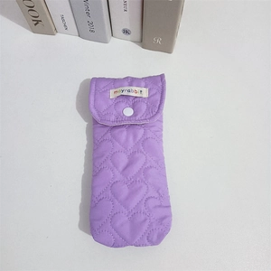 Close-up of purple quilted heart pattern case with a secure white snap button closure