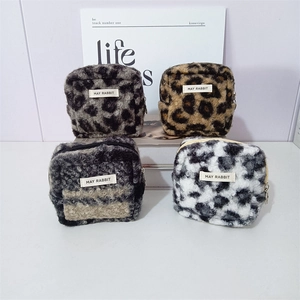Set of 4 plush leopard and zebra print makeup bags with zippers and branded labels
