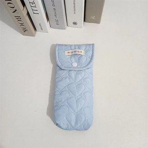 Detail of light blue quilted heart pattern glasses case with white snap button closure