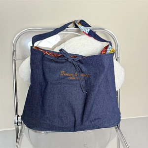 Deep blue denim tote bag with Fantasy Romance embroidery and floral lining interior