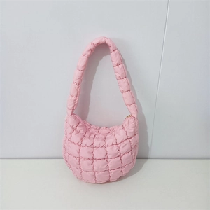 Detailed close-up of pink quilted cloud bag with padded texture and metallic zipper