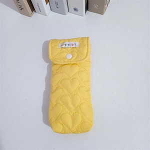 Detailed macro view of yellow quilted heart texture and mayrabbit button flap