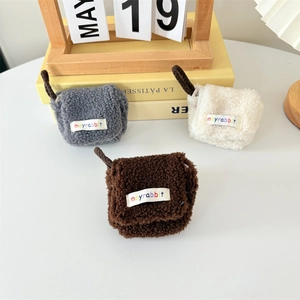 Three plush lamb wool earphone cases in grey, cream, and brown with woven lanyards
