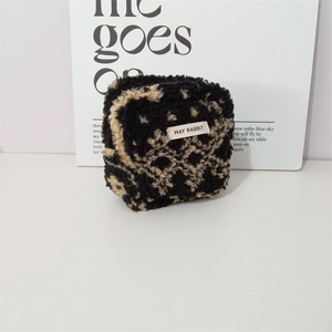 Close-up of leopard print plush bag with MAY RABBIT tag and soft textured fabric