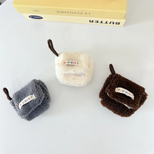 Three plush mini storage bags in grey, cream, and brown for AirPods with soft lamb wool texture