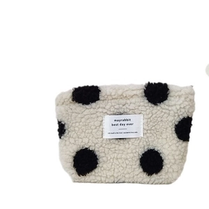 Winter plush cosmetic bag with black polka dots and sheep wool texture for travel