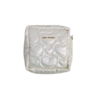 Quilted heart pattern cosmetic bag in pearl white with zip closure and logo patch