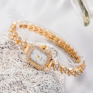Detailed macro view of a square gold watch dial with sparkling rhinestones and metal chain