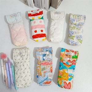 Set of quilted cotton pencil cases with button closure in various colorful patterns