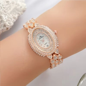 Rose gold oval quartz watch for women with sparkling rhinestones on band and bezel