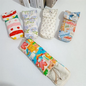 Detailed view of quilted cotton eyewear pouches with various patterns and snap closure
