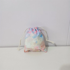 Close-up of a floral cotton drawstring bag with watercolor patterns and white dual cords