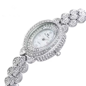 Detail of luxury silver steel watch featuring leaf-shaped crystal-encrusted strap and dial