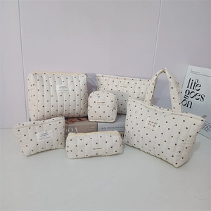 Detailed set of six quilted heart pattern storage bags and pouches with metal zippers