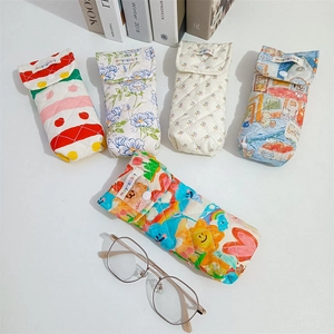 Five styles of quilted cotton eyeglass cases with floral and cartoon prints and metal snaps
