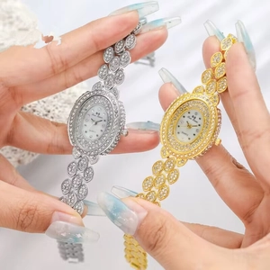 Luxury oval women's quartz watch with sparkling rhinestones and leaf-shaped steel band