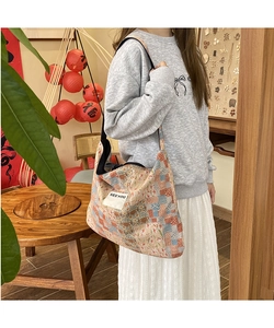 Detail of bohemian patchwork tote bag featuring geometric floral patterns and SEEYOU label