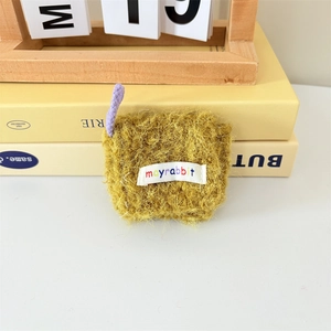 Close-up of yellow plush mini earphone pouch with purple strap and logo label